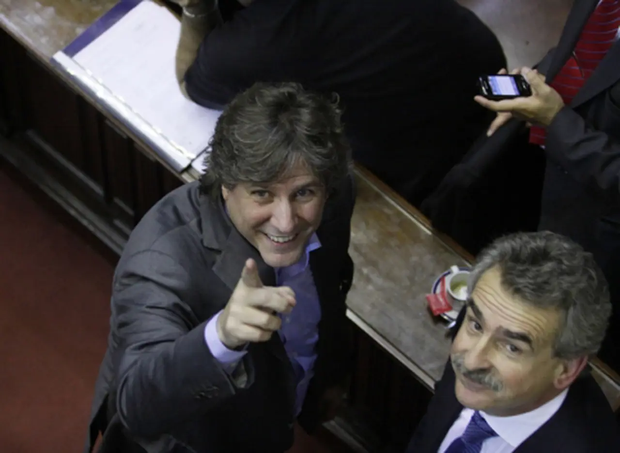 En medio de gritos y denuncias de fraude, Amado Boudou y Agustí­n Rossi se mostraron felices y a los abrazos por la reforma