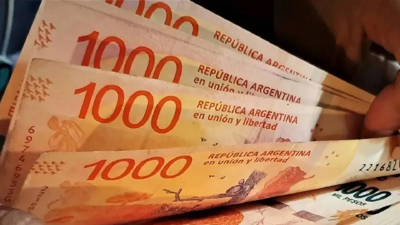 Dedos contando billetes de mil pesos