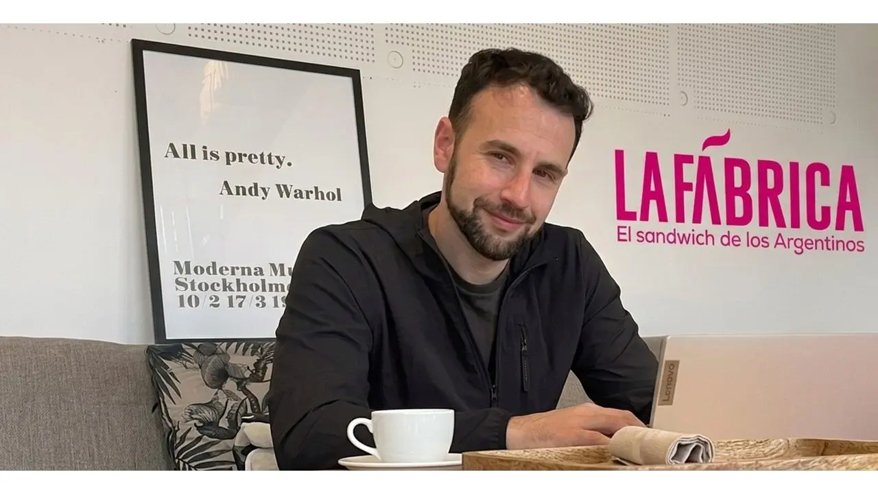 Ariel Matyas en la oficina con cartel de La Fábrica de fondo (Gentileza La Fábrica)