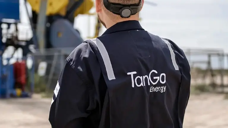 Operario de Tango Energy parado frente a un pozo petrolero de Vaca Muerta. Imagen de archivo