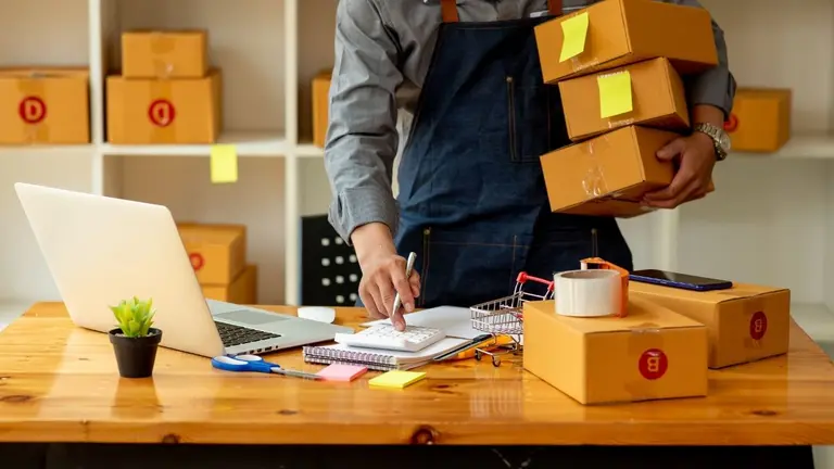 Persona con un emprendimiento con una computadora que le permite cobrar de manera online