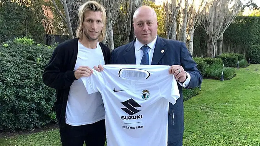 Caselli y el futbolista Gastón Machín posan con la camiseta del Burgos CF.